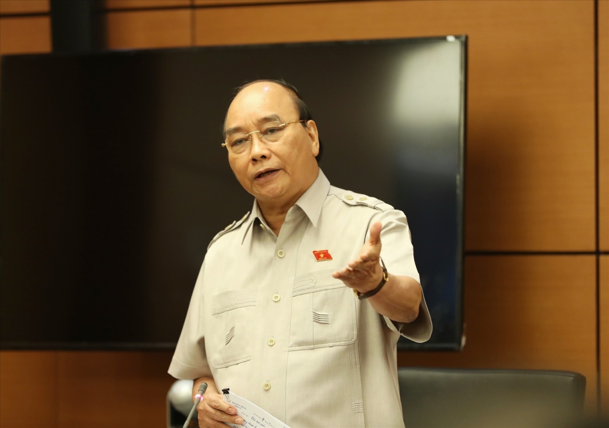 Chủ tịch nước Nguyễn Xuân Phúc tại một phiên thảo luận tổ (Ảnh: VGP)